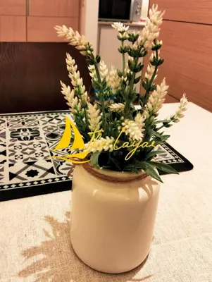 a vase with flowers in it on a table at Swiss Garden Residence by The Layar Homes in Kuala Lumpur