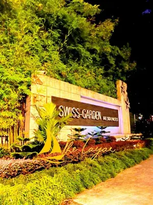 a swiss garden sign on the side of a building at Swiss Garden Residence by The Layar Homes in Kuala Lumpur