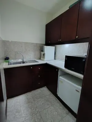 a small kitchen with a sink and a microwave at Grand Lumia Suite At Times Square KL in Kuala Lumpur