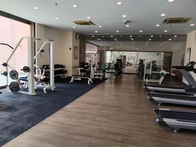 a gym with treadmills and machines in a room at Grand Lumia Suite At Times Square KL in Kuala Lumpur