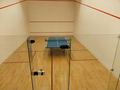 a tennis court with a table in a room at Grand Lumia Suite At Times Square KL in Kuala Lumpur
