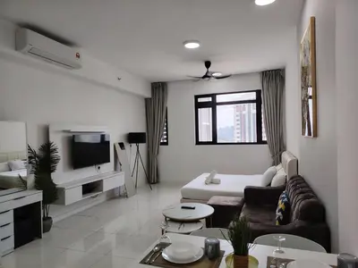 a living room with a couch and a tv at SUITES At CHAMBERS KLCC KUALALAMPUR in Kuala Lumpur