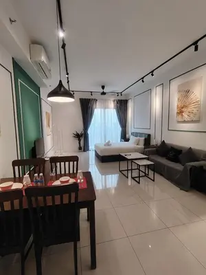 a living room with a couch and a table at SUITES At CHAMBERS KLCC KUALALAMPUR in Kuala Lumpur