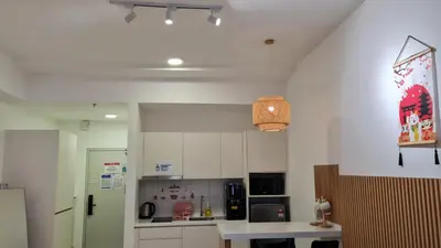 a kitchen with white cabinets and a white counter top at SUITES At CHAMBERS KLCC KUALALAMPUR in Kuala Lumpur