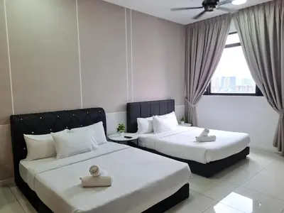 a hotel room with two beds and a window at SUITES At CHAMBERS KLCC KUALALAMPUR in Kuala Lumpur