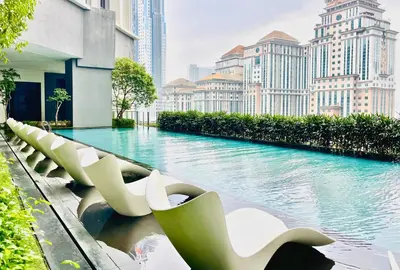a pool in the middle of a city with tall buildings at The Mews KLCC Service Suites in Kuala Lumpur
