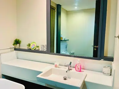 a bathroom with a white sink and a mirror at The Mews KLCC Service Suites in Kuala Lumpur