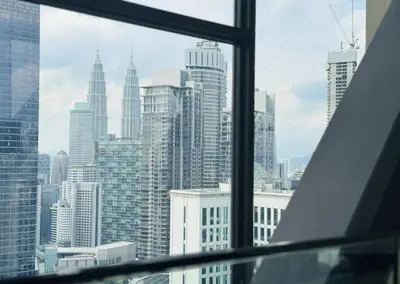 a view of a city skyline from a window at Axon Purple Suite Kuala Lampur in Kuala Lumpur