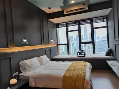 a bedroom with a large bed with a large window at Ceylonz Suites, Bukit Bintang, Kuala Lumpur in Kuala Lumpur