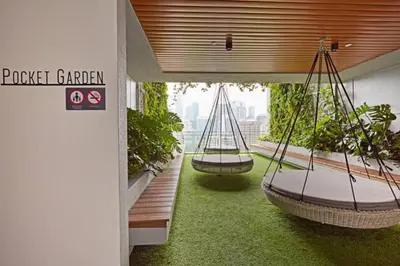 two hanging hammocks in a room with plants at Ceylonz Suites, Bukit Bintang, Kuala Lumpur in Kuala Lumpur