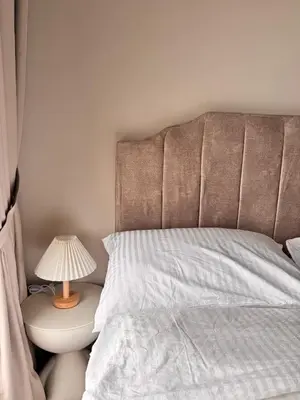 a bedroom with a bed and a lamp on a table at Luxury Sky Homes with KLCC VIEW in Kuala Lumpur