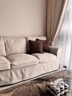a living room with a couch and a window at Luxury Sky Homes with KLCC VIEW in Kuala Lumpur
