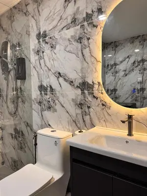 a bathroom with a toilet and a sink and a mirror at Luxury Sky Homes with KLCC VIEW in Kuala Lumpur