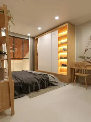 a bedroom with a bed and a wooden cabinet at Mayavi Property in Kuala Lumpur