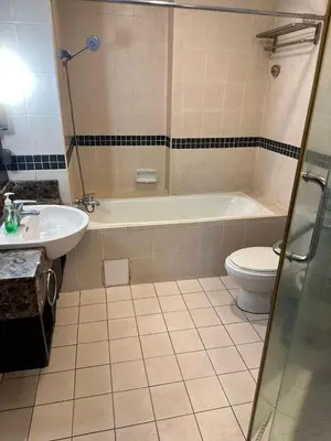 a bathroom with a tub and a toilet and a sink at Sweet cozy house by seri bukit Ceylon in Kuala Lumpur