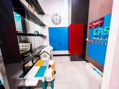 a room with two tables and a clock on the wall at KidsCastle Dorsett Pavillion in Kuala Lumpur