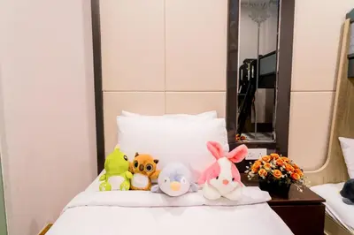 a group of stuffed animals sitting on top of a bed at KidsCastle Dorsett Pavillion in Kuala Lumpur