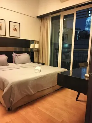 a hotel room with a bed and a large window at seri bukit ceylon by sweet cozy house in Kuala Lumpur