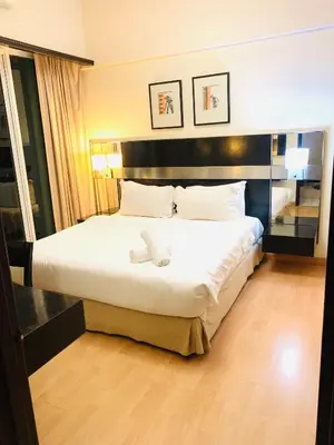 a hotel room with a bed with a stuffed animal on it at seri bukit ceylon by sweet cozy house in Kuala Lumpur