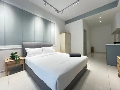 a bedroom with a large white bed and a table at The Majestic Residence By Awesomestay in Kuala Lumpur