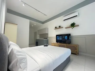a bedroom with a bed and a flat screen tv at The Majestic Residence By Awesomestay in Kuala Lumpur