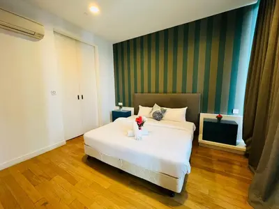 a bedroom with a white bed with flowers on it at Majestic Infinity Pool by KLCC in Kuala Lumpur