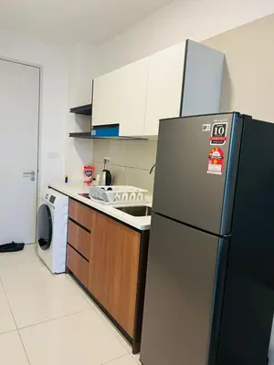 a kitchen with a refrigerator and a washing machine at Majestic Infinity Pool by KLCC in Kuala Lumpur