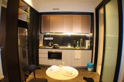 a small kitchen with a small table in a room at Scarletz Service Suites KLCC in Kuala Lumpur