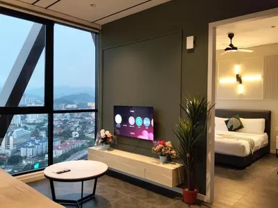 a bedroom with a bed and a tv in a room at Scarletz Service Suites KLCC in Kuala Lumpur