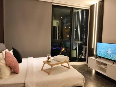 a living room with a white couch and a television at Hospitality Service Suites Scarlitz KLCC in Kuala Lumpur