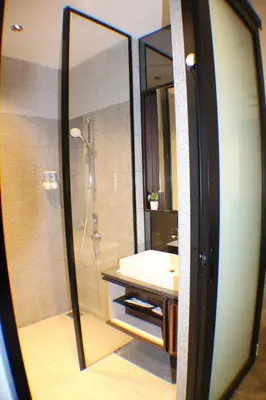 a bathroom with a shower and a sink and a mirror at Hospitality Service Suites Scarlitz KLCC in Kuala Lumpur