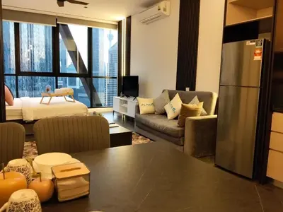 a kitchen and living room with a large window at Hospitality Service Suites Scarlitz KLCC in Kuala Lumpur