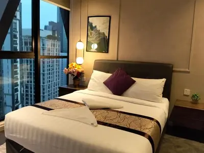 a bedroom with a bed and a large window at Hospitality Service Suites Scarlitz KLCC in Kuala Lumpur