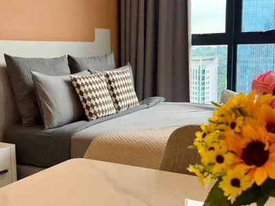 a bedroom with a bed and a couch and a window at The Majestic Residence Suites By Casabellestay in Kuala Lumpur