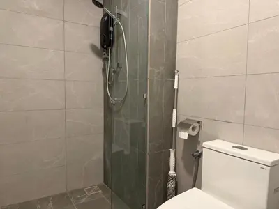 a bathroom with a toilet and a glass shower at The Majestic Residence Suites By Casabellestay in Kuala Lumpur