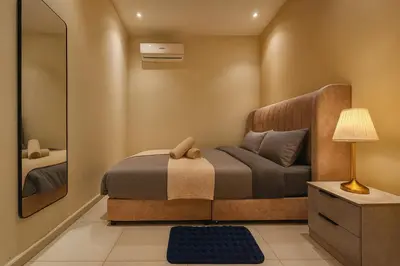 a small bedroom with a bed and a mirror at The Majestic Residence Suites By Casabellestay in Kuala Lumpur