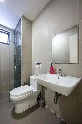 a bathroom with a sink and a toilet and a mirror at KL City Central TRX 3 Bedrooms 2 Baths & Balcony in Kuala Lumpur