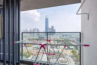 a large window with a view of a city at KL City Central TRX 3 Bedrooms 2 Baths & Balcony in Kuala Lumpur