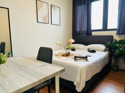 a bedroom with a bed with a table and a table and chairs at MVA19#Family Suite 8 pax 3 Rooms Sunway Velocity Mall, MRT Maluri Cheras in Kuala Lumpur