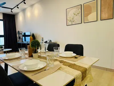 a dining room table with plates and glasses on it at MVA19#Family Suite 8 pax 3 Rooms Sunway Velocity Mall, MRT Maluri Cheras in Kuala Lumpur