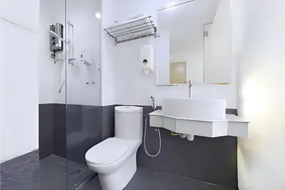 a bathroom with a white toilet and a sink at Hotel Pollodium Chinatown KL in Kuala Lumpur