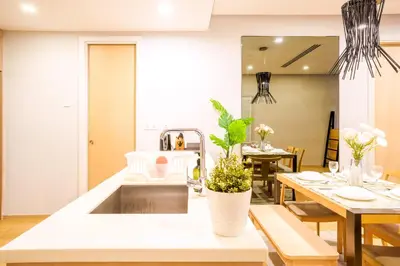 a kitchen with a sink and a dining table at 188 Suites by KidsCastle in Kuala Lumpur
