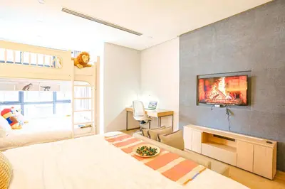 a bedroom with a bed and a tv on a wall at 188 Suites by KidsCastle in Kuala Lumpur