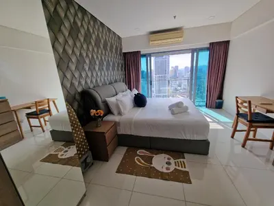 a hotel room with a bed and a view of the city at Cozy Family Suite 5pax KLCC by SS HOME in Kuala Lumpur