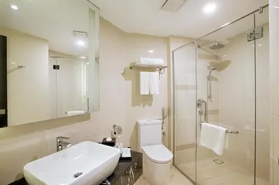 a bathroom with a sink and a toilet and a shower at WP Hotel in Kuala Lumpur