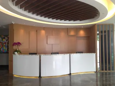 an office lobby with a white counter and a ceiling at WP Hotel in Kuala Lumpur
