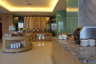 a restaurant with a counter with bottles of water at WP Hotel in Kuala Lumpur
