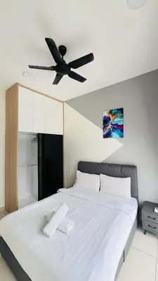a bedroom with a bed with a ceiling fan at TRION KL Premier Residence in Kuala Lumpur