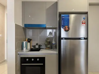 a kitchen with a stainless steel refrigerator and a stove at Comfy 1BR klcc view imperial suite B47 09 Trion KL in Kuala Lumpur