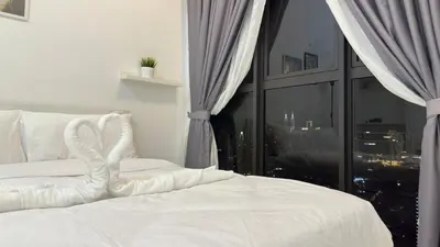 a bedroom with a white bed with a window at Couple home Netflix free parking A45 08St Trion KL in Kuala Lumpur